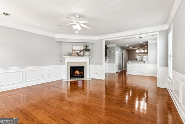3725 Downing Dr, Cumming, GA 30040 - unfurnished living room featuring a ceiling fan, crown molding, a fireplace with flush hearth, wood finished floors, and a decorative wall