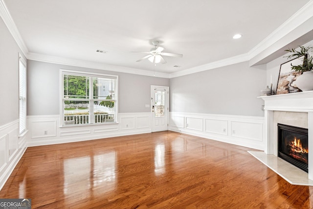 3725 Downing Dr, Cumming, GA 30040 - unfurnished living room with a high end fireplace, ceiling fan, wainscoting, wood finished floors, and crown molding