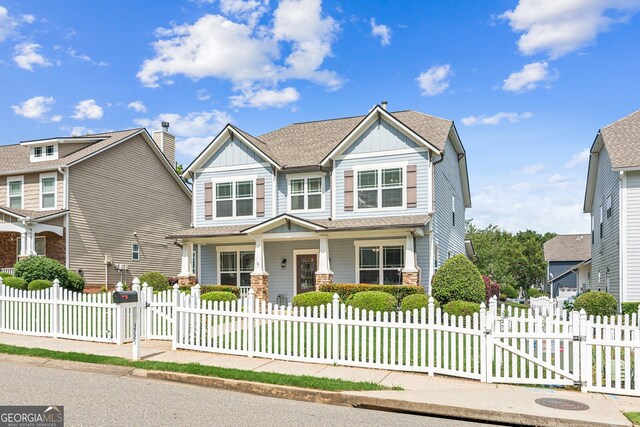 3725 Downing Dr, Cumming, GA 30040 - craftsman-style home with a gate, board and batten siding, a porch, and a fenced front yard