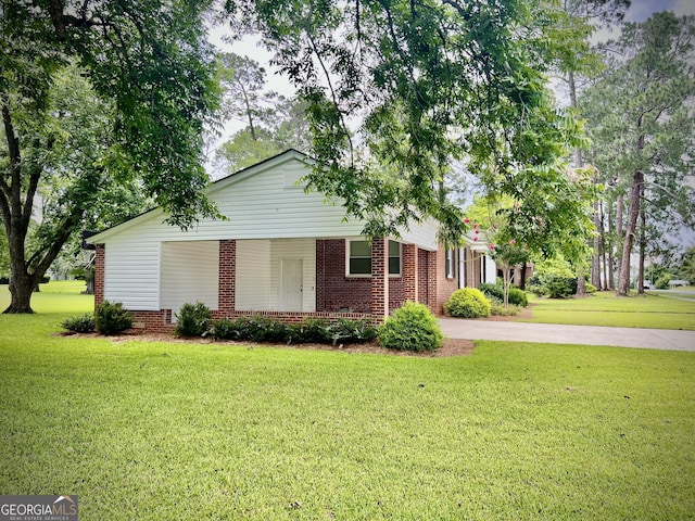 319 N Line St, Dexter, GA 31019 - single story home featuring a front lawn, brick siding, and concrete driveway