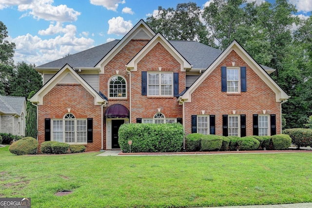 1868 Birch Briar Bnd, Lawrenceville, GA 30043 - view of front facade featuring brick siding, a front lawn, and a shingled roof