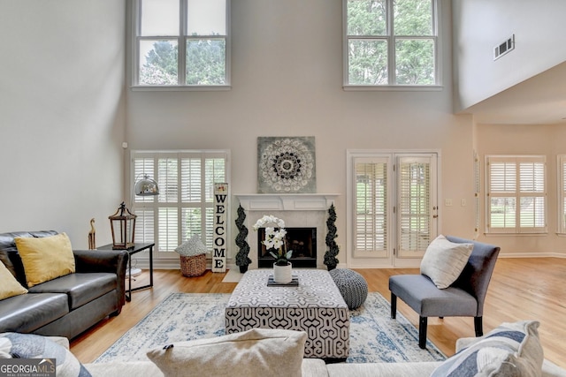 1868 Birch Briar Bnd, Lawrenceville, GA 30043 - living area featuring a high ceiling, healthy amount of natural light, and a fireplace