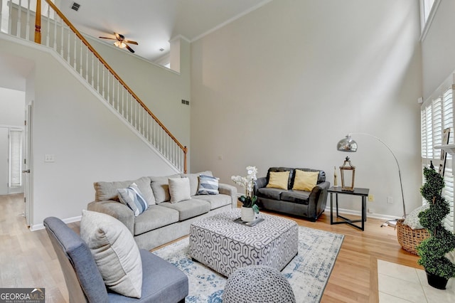 1868 Birch Briar Bnd, Lawrenceville, GA 30043 - living area featuring a high ceiling, stairway, a ceiling fan, and wood finished floors