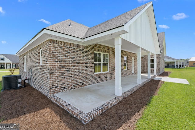 3 Honeysuckle Dr, Claxton, GA 30417 - rear view of house featuring brick siding, a patio, a yard, and a shingled roof