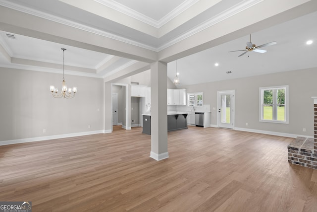3 Honeysuckle Dr, Claxton, GA 30417 - unfurnished living room with ceiling fan, a chandelier, light wood-style floors, ornamental molding, and a brick fireplace