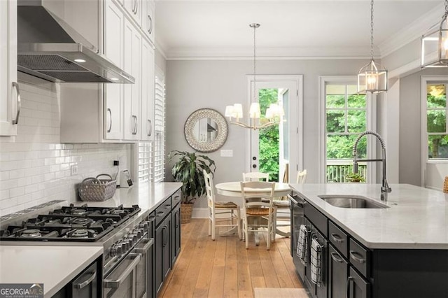 127 Oak Ln, Decatur, GA 30030 - kitchen with wall chimney exhaust hood, white cabinets, a chandelier, dark cabinets, and double oven range