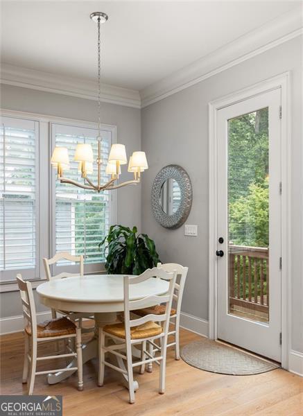 127 Oak Ln, Decatur, GA 30030 - dining space with a chandelier, light wood finished floors, and crown molding