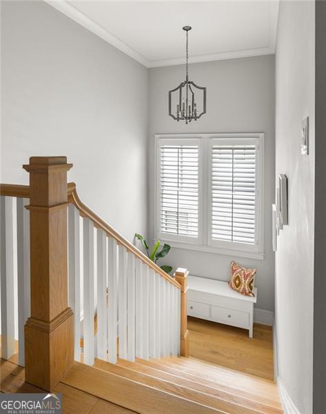 127 Oak Ln, Decatur, GA 30030 - staircase featuring wood finished floors, a chandelier, and crown molding