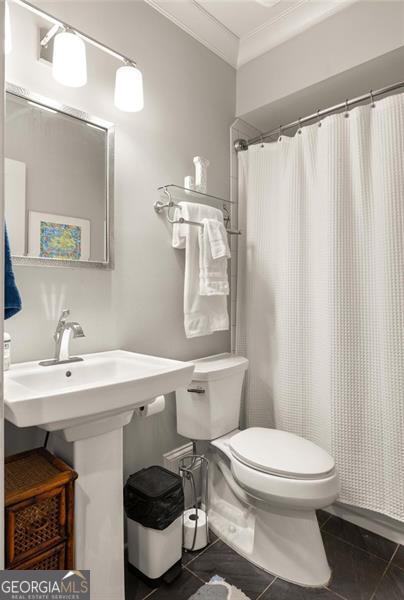 127 Oak Ln, Decatur, GA 30030 - bathroom featuring tile patterned flooring, crown molding, and a shower with curtain