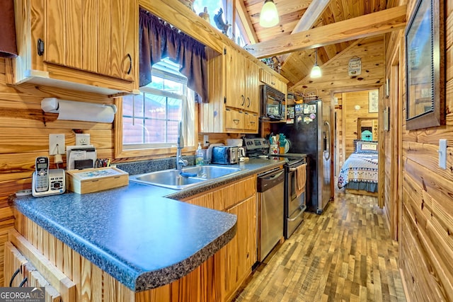 77 Falls View Dr, Dillard, GA 30537 - kitchen with appliances with stainless steel finishes, dark countertops, light wood-style floors, wooden walls, and a peninsula