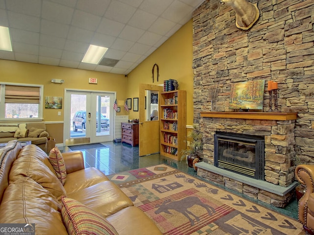 77 Falls View Dr, Dillard, GA 30537 - tiled living area with french doors, a stone fireplace, and a towering ceiling