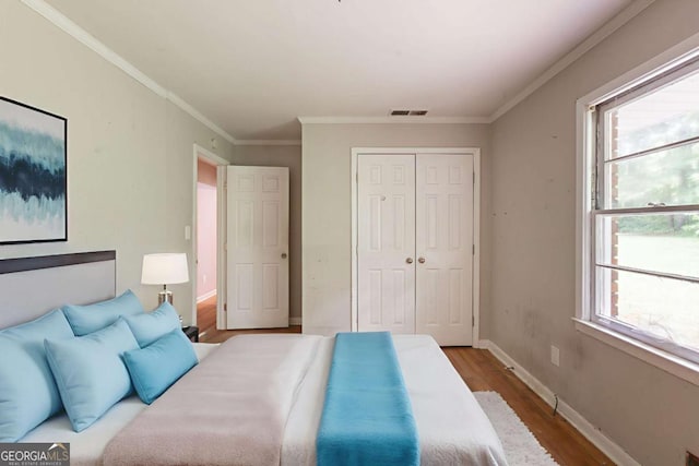 4201 Hicks Rd, Austell, GA 30106 - bedroom with wood finished floors, a closet, and ornamental molding