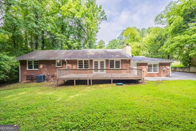 4201 Hicks Rd, Austell, GA 30106 - rear view of property featuring a deck, a lawn, brick siding, and a chimney