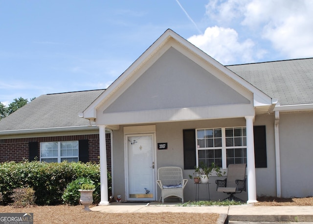 2887 Florence Dr, Gainesville, GA 30504 - view of front of property featuring covered porch, brick siding, roof with shingles, and stucco siding
