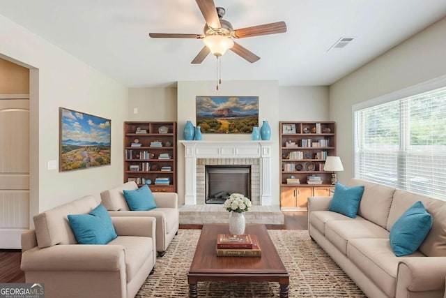 2317 Church St, Hampton, GA 30228 - living area with a ceiling fan, wood finished floors, and a fireplace