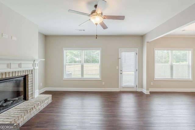 2317 Church St, Hampton, GA 30228 - unfurnished living room with dark wood-style floors, plenty of natural light, ceiling fan, and a brick fireplace