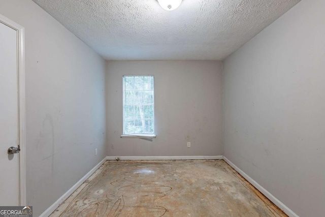 5856 Rock Rd, Union City, GA 30291 - spare room featuring baseboards and a textured ceiling