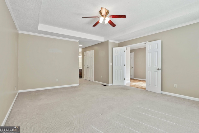 118 Whitfield Run, Peachtree City, GA 30269 - unfurnished bedroom featuring light carpet, crown molding, a textured ceiling, a raised ceiling, and a ceiling fan