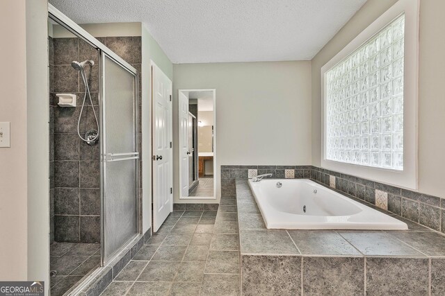 118 Whitfield Run, Peachtree City, GA 30269 - full bathroom with a shower stall, a tub with jets, and a textured ceiling