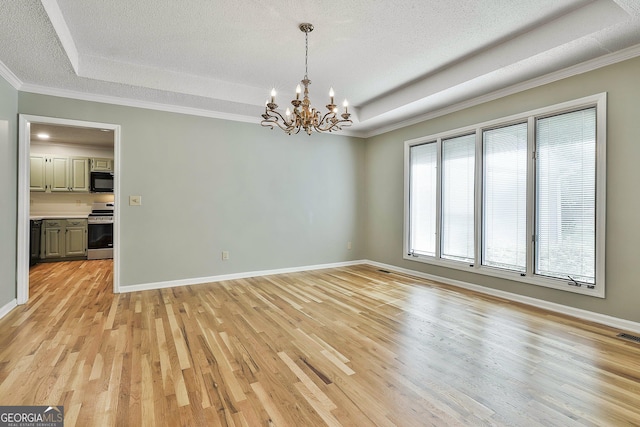 118 Whitfield Run, Peachtree City, GA 30269 - empty room with a tray ceiling, a chandelier, light wood-style floors, ornamental molding, and a textured ceiling
