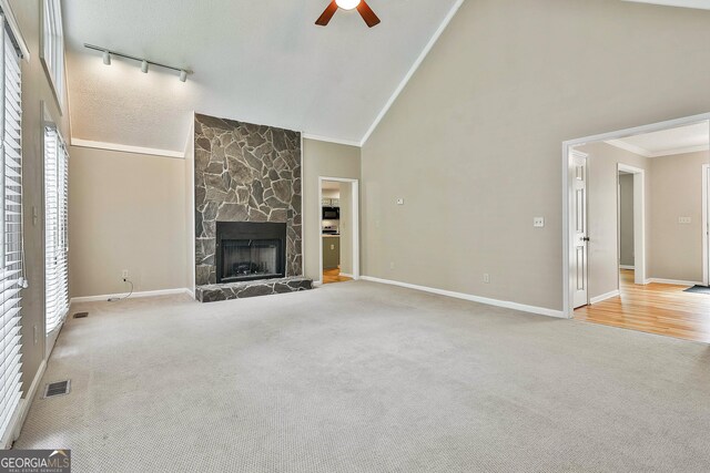 118 Whitfield Run, Peachtree City, GA 30269 - unfurnished living room with ceiling fan, carpet floors, rail lighting, a fireplace, and high vaulted ceiling