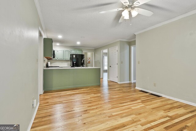 118 Whitfield Run, Peachtree City, GA 30269 - unfurnished living room with a textured ceiling, ceiling fan, light wood-style flooring, ornamental molding, and recessed lighting