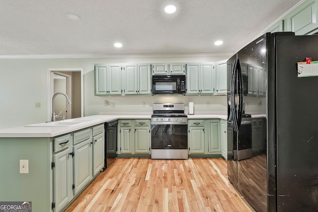 118 Whitfield Run, Peachtree City, GA 30269 - kitchen with black appliances, green cabinetry, a peninsula, light wood-type flooring, and crown molding