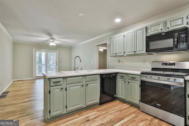 118 Whitfield Run, Peachtree City, GA 30269 - kitchen featuring black appliances, a peninsula, a textured ceiling, ornamental molding, and light countertops