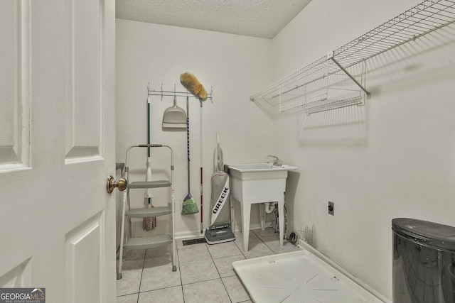 118 Whitfield Run, Peachtree City, GA 30269 - laundry area featuring hookup for an electric dryer, tile patterned flooring, and a textured ceiling