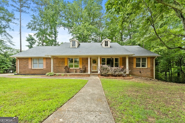 1290 Shadowlawn Dr NE, Conyers, GA 30012 - cape cod home with covered porch, a front lawn, brick siding, and a shingled roof