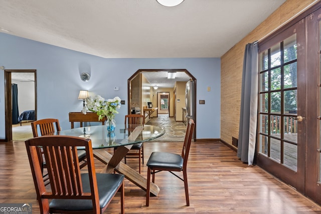 1290 Shadowlawn Dr NE, Conyers, GA 30012 - dining area featuring arched walkways and light wood-style floors