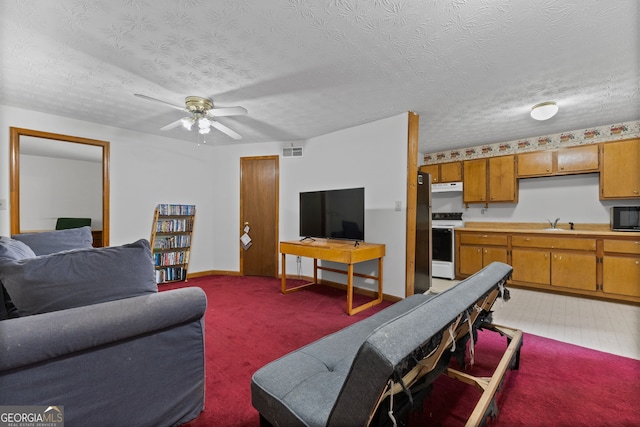 1290 Shadowlawn Dr NE, Conyers, GA 30012 - living room featuring ceiling fan, a textured ceiling, and light colored carpet