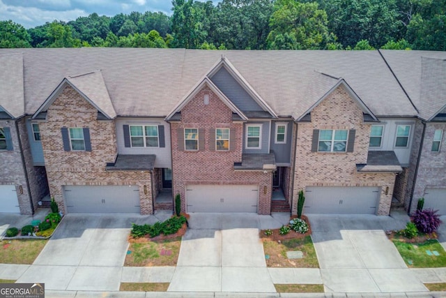 2005 Hamilton Creek Pkwy, Dacula, GA 30019 - view of property featuring a garage, driveway, and brick siding