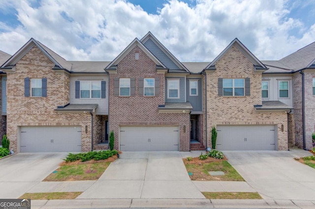 2005 Hamilton Creek Pkwy, Dacula, GA 30019 - townhome / multi-family property featuring an attached garage, brick siding, and driveway