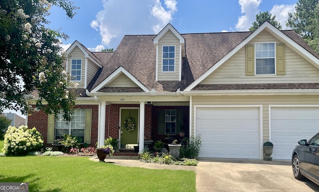 221 Turtle Cv, Carrollton, GA 30116 - view of front facade featuring roof with shingles, concrete driveway, a front yard, and brick siding