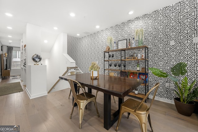 383 Pratt Dr Unit 506, Atlanta, GA 30315 - dining space featuring an accent wall, wallpapered walls, wood finished floors, recessed lighting, and stairway