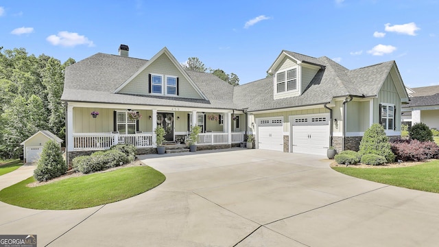 459 N Cove Dr, Newnan, GA 30263 - view of front of home with board and batten siding, covered porch, a shingled roof, an attached garage, and concrete driveway
