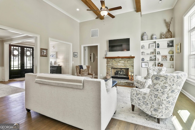 459 N Cove Dr, Newnan, GA 30263 - living area with ceiling fan, a fireplace, a towering ceiling, wood finished floors, and crown molding