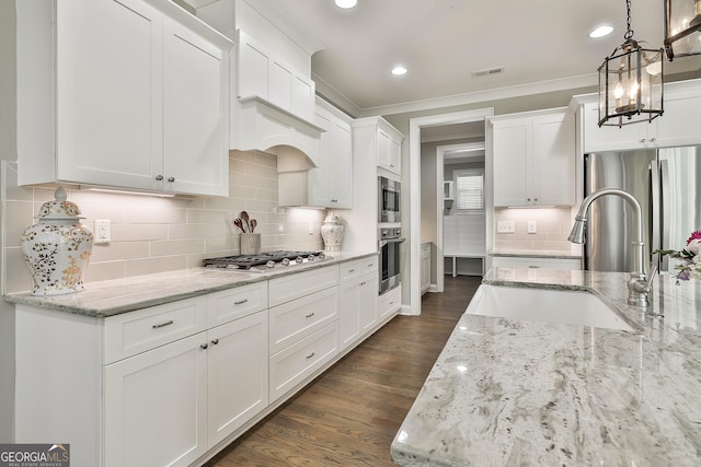 459 N Cove Dr, Newnan, GA 30263 - kitchen with stainless steel appliances, dark wood-style flooring, ornamental molding, white cabinetry, and recessed lighting