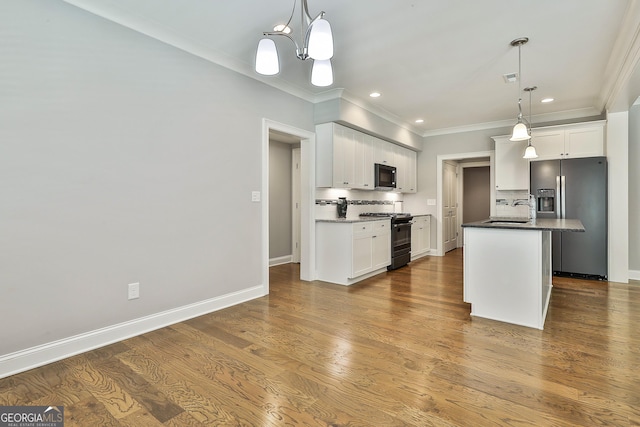 459 N Cove Dr, Newnan, GA 30263 - kitchen featuring range with gas cooktop, stainless steel refrigerator with ice dispenser, black microwave, crown molding, and backsplash