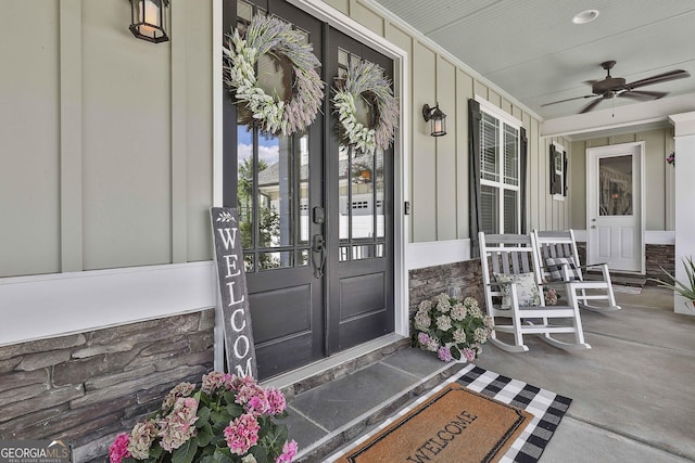 459 N Cove Dr, Newnan, GA 30263 - view of exterior entry with stone siding, covered porch, board and batten siding, and french doors