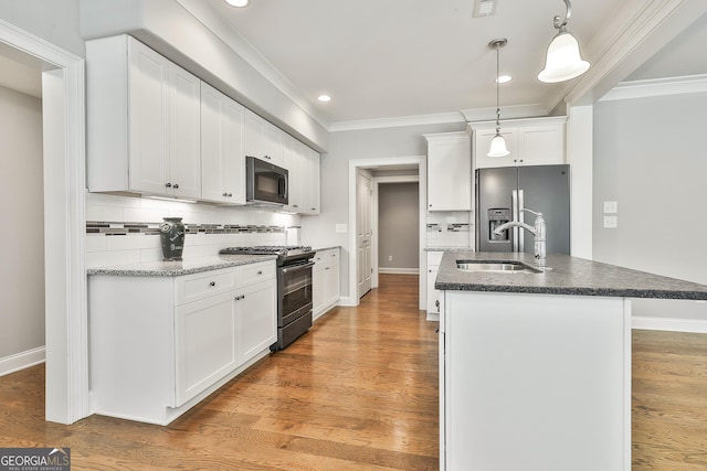 459 N Cove Dr, Newnan, GA 30263 - kitchen featuring gas range, stainless steel fridge with ice dispenser, backsplash, a center island with sink, and white cabinets