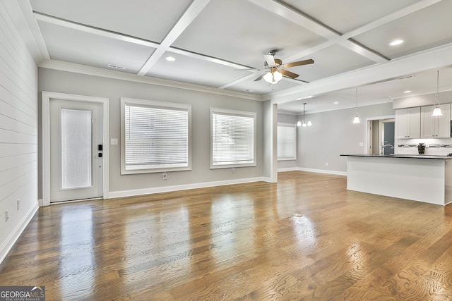 459 N Cove Dr, Newnan, GA 30263 - unfurnished living room featuring coffered ceiling, a ceiling fan, a chandelier, beam ceiling, and ornamental molding