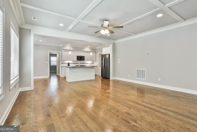 459 N Cove Dr, Newnan, GA 30263 - unfurnished living room with coffered ceiling, a ceiling fan, plenty of natural light, recessed lighting, and wood finished floors
