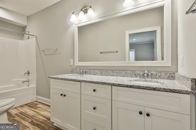 459 N Cove Dr, Newnan, GA 30263 - bathroom featuring double vanity, wood finished floors, and shower / bathtub combination