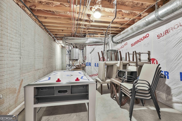 459 N Cove Dr, Newnan, GA 30263 - unfinished below grade area featuring brick wall and tankless water heater