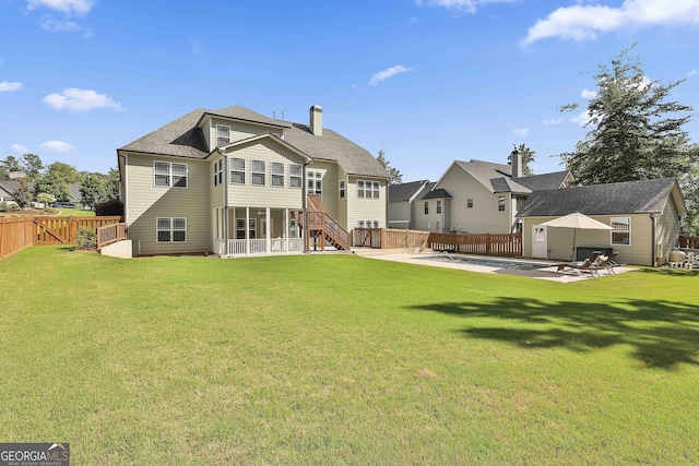 459 N Cove Dr, Newnan, GA 30263 - rear view of property featuring a fenced backyard, an outdoor structure, a chimney, a patio area, and a shingled roof