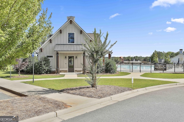459 N Cove Dr, Newnan, GA 30263 - modern inspired farmhouse with board and batten siding, a community pool, and a chimney