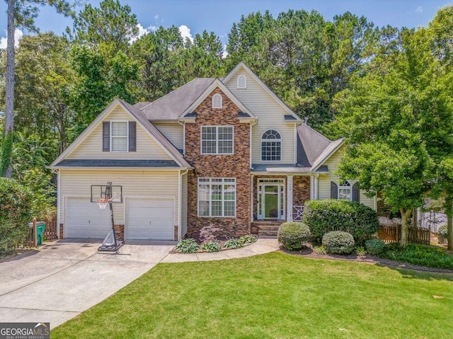 119 Creekside Vw, Hiram, GA 30141 - view of front of house with stone siding, concrete driveway, an attached garage, and view of scattered trees