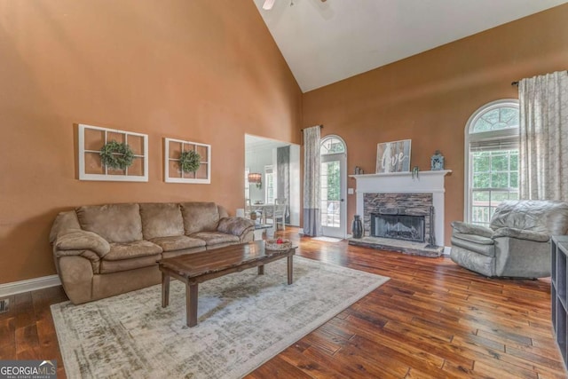 119 Creekside Vw, Hiram, GA 30141 - living area with high vaulted ceiling, plenty of natural light, dark wood-type flooring, a stone fireplace, and ceiling fan
